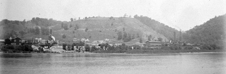 Wellsville, Ohio, seen from across the Ohio River — mills and houses along the riverbank below the hills